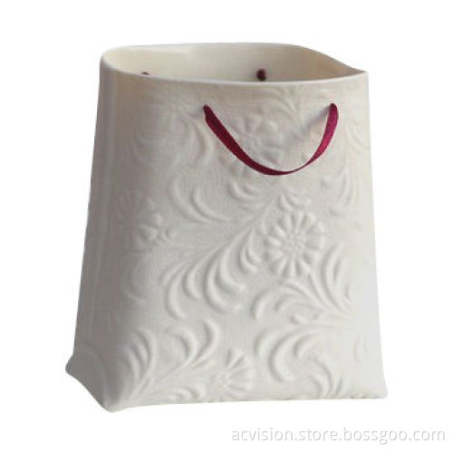 Handbag shape ceramic vase with a red rope